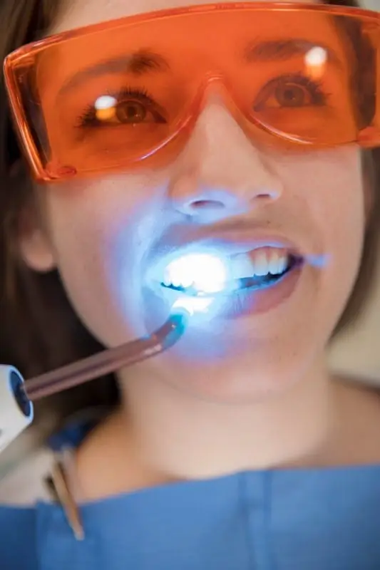 patient with glasses and dental laser